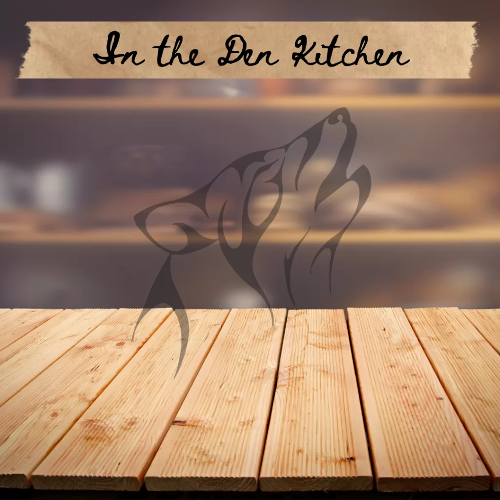Blurred image of a kitchen with the words In the Den Kitchen.