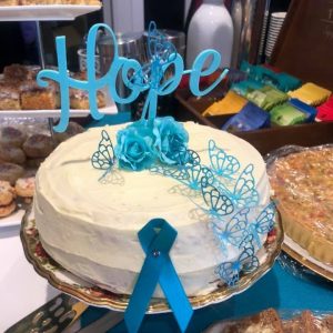 White cake with teal decorations